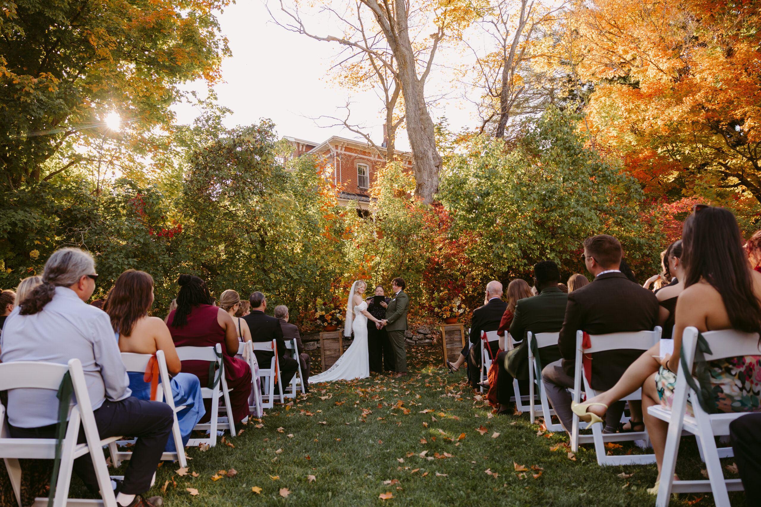 Lexi and Taylor sharing a first look at Millcroft Inn before their fall wedding at Alton Mill Art Centre